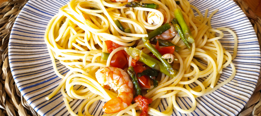 Espaguetis con espárragos, tomates y langostinos